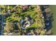 An aerial view shows a home with lake access, a private dock, and lush, green landscaping at 16011 Acorn Cir, Tavares, FL 32778
