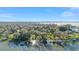 Breathtaking aerial view of lakefront property with lush trees and a private dock at 16011 Acorn Cir, Tavares, FL 32778