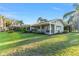 Expansive backyard with a screened porch and lush greenery at 16011 Acorn Cir, Tavares, FL 32778