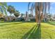 Lush backyard featuring a pool, screened enclosure, and comfortable outdoor seating at 16011 Acorn Cir, Tavares, FL 32778