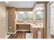 Bright bathroom with a large window with blinds, vanity sink and open storage at 16011 Acorn Cir, Tavares, FL 32778