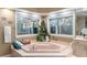 Bathroom featuring a corner soaking tub with natural light from surrounding windows at 16011 Acorn Cir, Tavares, FL 32778