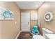 Cozy bathroom with nautical decor, a toilet, and an exterior door for convenience at 16011 Acorn Cir, Tavares, FL 32778