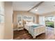 Bright bedroom featuring wood floors, a ceiling fan, and a view of the outdoors at 16011 Acorn Cir, Tavares, FL 32778