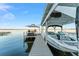 Boat dock featuring boat lift, seating area, and stunning lake views at 16011 Acorn Cir, Tavares, FL 32778
