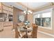 Bright dining area with glass table, wicker chairs and abundant natural light at 16011 Acorn Cir, Tavares, FL 32778