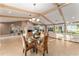 Open floor plan with beamed ceilings and a dining area with waterfront views at 16011 Acorn Cir, Tavares, FL 32778