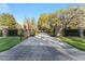 Long driveway leading through a gated entrance and lush greenery to the property at 16011 Acorn Cir, Tavares, FL 32778
