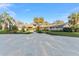 Spacious home featuring a circular driveway, beautiful landscaping, and mature palm trees at 16011 Acorn Cir, Tavares, FL 32778