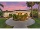 Charming home with a circular driveway and lush landscaping in a serene setting at 16011 Acorn Cir, Tavares, FL 32778