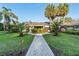 Attractive single-story home with a lush front lawn and inviting walkway at 16011 Acorn Cir, Tavares, FL 32778