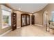Bright foyer with tile flooring, dark wood doors, and view to front yard at 16011 Acorn Cir, Tavares, FL 32778