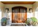 Stunning front entrance with a wood door, detailed stonework, and elegant lighting at 16011 Acorn Cir, Tavares, FL 32778