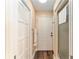 Hallway features wood flooring, storage closet and bathroom with walk-in shower at 16011 Acorn Cir, Tavares, FL 32778