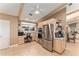 Well-lit kitchen with stainless steel appliances, built in desk, and ample cabinet space at 16011 Acorn Cir, Tavares, FL 32778