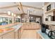 Bright kitchen features tile counters, pendant lighting, an island, and stainless steel appliances at 16011 Acorn Cir, Tavares, FL 32778
