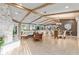 Spacious living area with stone fireplace, beamed ceilings, and waterfront views at 16011 Acorn Cir, Tavares, FL 32778