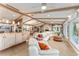 Bright open concept living room and kitchen area features a fireplace and natural light at 16011 Acorn Cir, Tavares, FL 32778