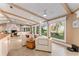 Open living space with beamed ceilings, tile flooring, and expansive water views at 16011 Acorn Cir, Tavares, FL 32778