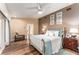 Bedroom with wood flooring, a walk-out to a private patio, and neutral paint at 16011 Acorn Cir, Tavares, FL 32778