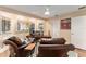 Comfortable office with a view, featuring wood floors, natural light, and comfortable leather chairs at 16011 Acorn Cir, Tavares, FL 32778