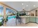 Entertain effortlessly from this outdoor kitchen overlooking the pool and lanai at 16011 Acorn Cir, Tavares, FL 32778