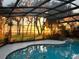 Enclosed pool area with beautiful water view perfect for sunrises, and relaxing in privacy at 16011 Acorn Cir, Tavares, FL 32778