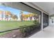 Serene screened-in porch with tranquil views of the lush, tree-lined property and lake at 16011 Acorn Cir, Tavares, FL 32778