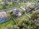 Aerial view of a fenced property featuring a pool, spacious yard, and mature landscaping in a residential neighborhood at 16620 Caravaggio Loop, Montverde, FL 34756