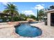 Beautiful pool with rock features, a waterfall, and an umbrella-shaded seating area for luxurious outdoor living at 16620 Caravaggio Loop, Montverde, FL 34756