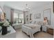 Bedroom with a chandelier, large window, neutral tones, a desk, and a cozy aesthetic at 16620 Caravaggio Loop, Montverde, FL 34756