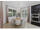 Bright dining area with a modern chandelier, light-colored walls, and large windows at 16620 Caravaggio Loop, Montverde, FL 34756