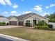 Beautiful single-story home featuring a three-car garage, manicured lawn, and brick-paved driveway at 16620 Caravaggio Loop, Montverde, FL 34756