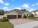 Charming home with a three-car garage, landscaped yard, and beautiful brick driveway at 16620 Caravaggio Loop, Montverde, FL 34756