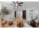 Cozy living room with ceiling fan, stylish furnishings, and white walls at 16620 Caravaggio Loop, Montverde, FL 34756