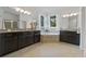 Spacious main bathroom with dual vanities, a soaking tub, and white curtains at 16620 Caravaggio Loop, Montverde, FL 34756