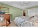 Relaxing guest bedroom featuring a large bed, side tables, and an ensuite bathroom at 16801 Se 74 Soulliere Ave, The Villages, FL 32162