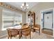 Cozy dining area features a round table with seating for four and a decorative china cabinet at 16801 Se 74 Soulliere Ave, The Villages, FL 32162