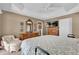 Well-lit main bedroom with tray ceiling, closet, ensuite bath, and classic furnishings at 16801 Se 74 Soulliere Ave, The Villages, FL 32162