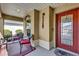 Welcoming screened porch with elegant door, tasteful decorations, and comfortable chairs at 16801 Se 74 Soulliere Ave, The Villages, FL 32162