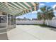 View of the home's back yard featuring an awning, white fence, and privacy at 1781 Kingfisher Ct, The Villages, FL 32162