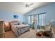 Comfortable bedroom with blue walls, a ceiling fan, and laminate flooring at 1781 Kingfisher Ct, The Villages, FL 32162