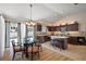 Bright kitchen and dining area featuring dark wood cabinets, a glass top table and modern appliances at 1781 Kingfisher Ct, The Villages, FL 32162