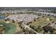 High-angle shot of houses surrounding a golf course and lake within a well-designed residential community at 1802 Dalton Dr, The Villages, FL 32162