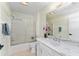 Bright bathroom featuring a shower and vanity with a white marble countertop at 1802 Dalton Dr, The Villages, FL 32162