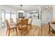 Dining area with glass-top table, upholstered chairs, and white kitchen at 1802 Dalton Dr, The Villages, FL 32162