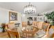 Dining area with glass-top table, upholstered chairs, and decorative lighting at 1802 Dalton Dr, The Villages, FL 32162