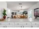 Bright dining room with a glass table and six upholstered chairs at 1802 Dalton Dr, The Villages, FL 32162