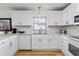 Bright kitchen featuring white cabinets, stainless steel appliances, and stylish countertops at 1802 Dalton Dr, The Villages, FL 32162