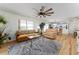 Bright living room featuring a large window, wood flooring, and opening to the kitchen at 1802 Dalton Dr, The Villages, FL 32162